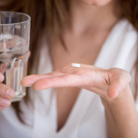 Lady prepares to take pill